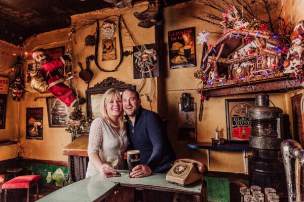 Two people smiling together at a table in the pub